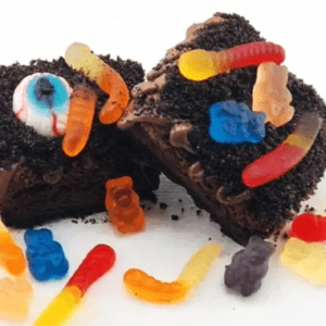 A brownie with chocolate frosting and gummy bears.