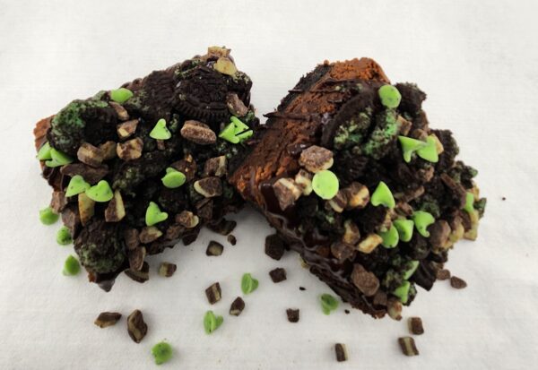 A close up of some brownies with green sprinkles