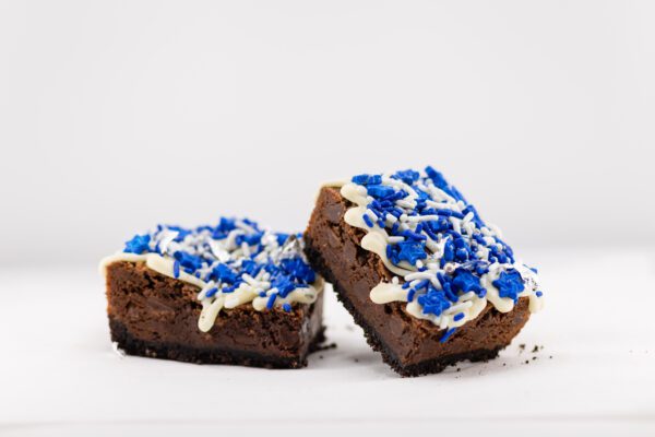 Two pieces of brownie with blue sprinkles on top.