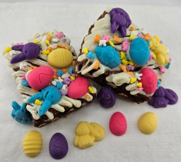 Homemade chocolate bark topped with colorful easter-themed candy decorations.