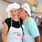 A man and woman kissing in aprons.