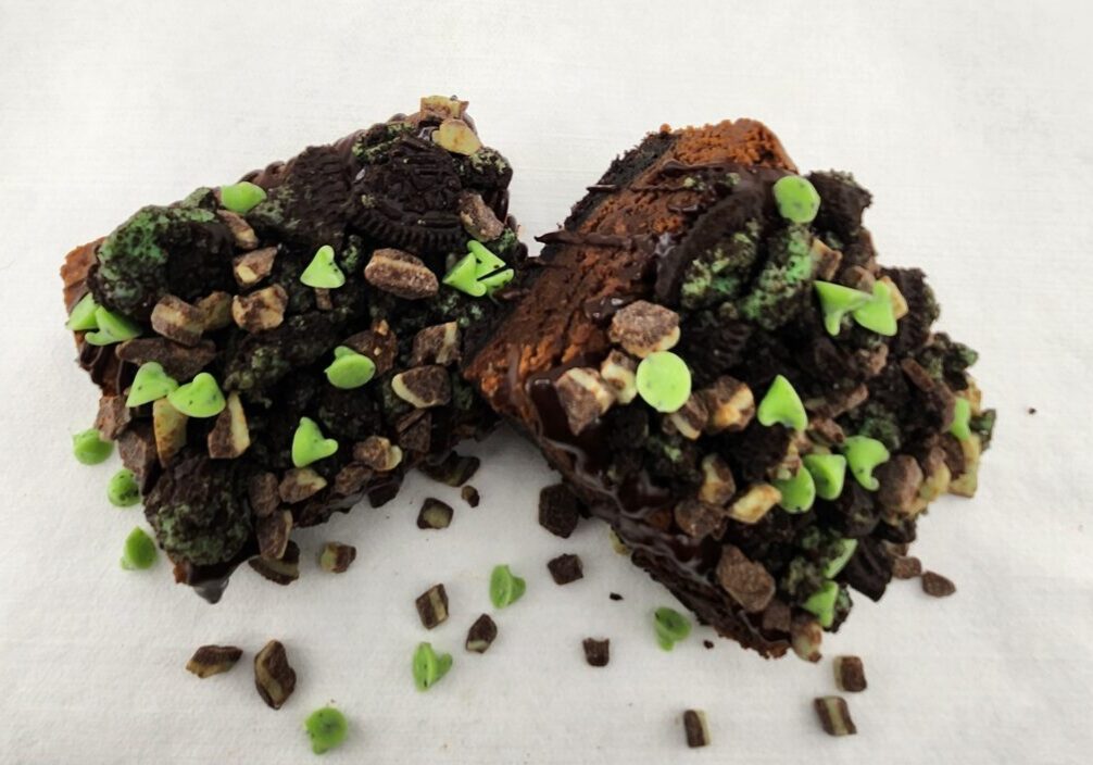 A close up of some brownies with green sprinkles